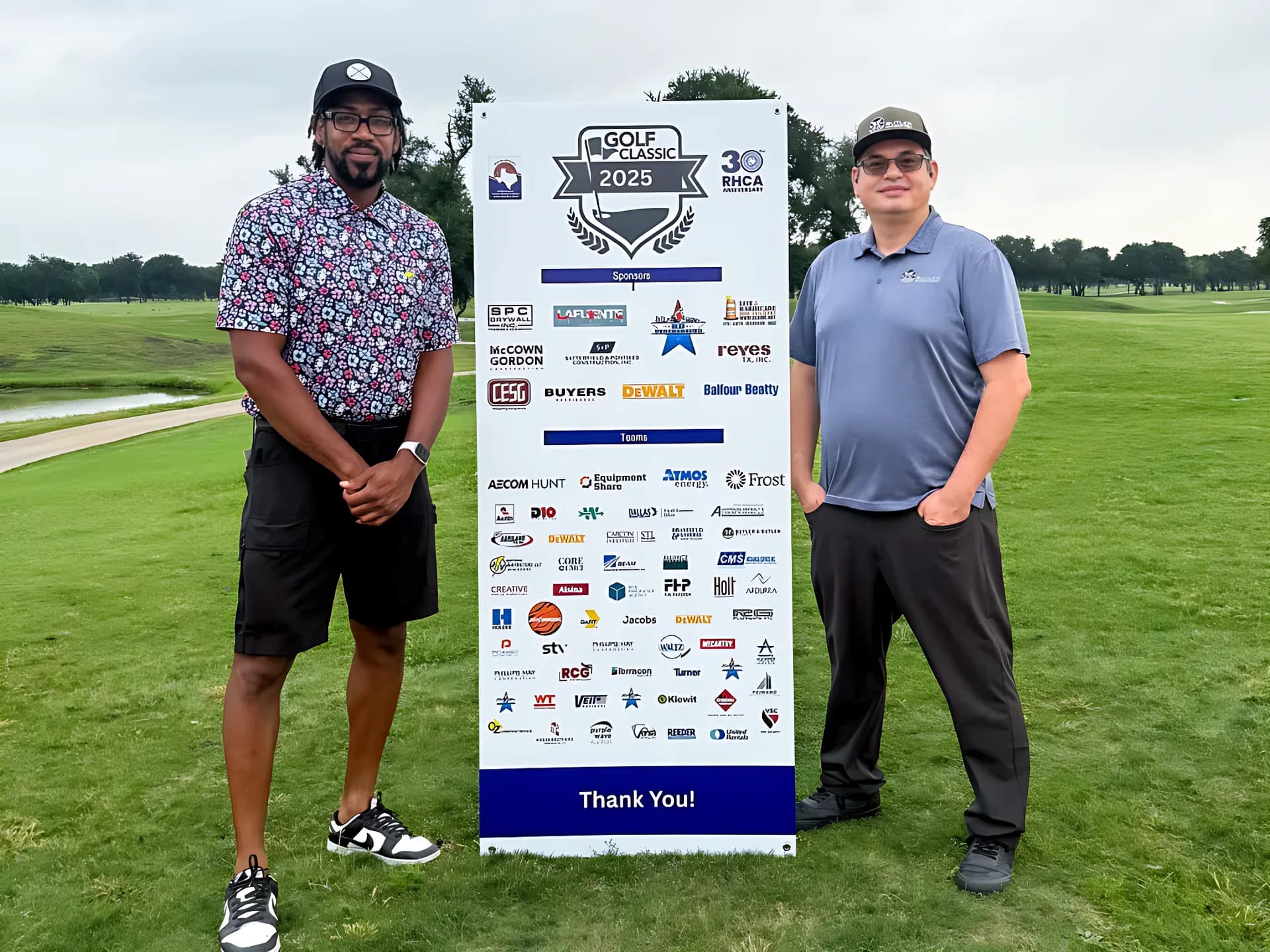 Players beside the sponsor board at the RHCA Golf Classic.